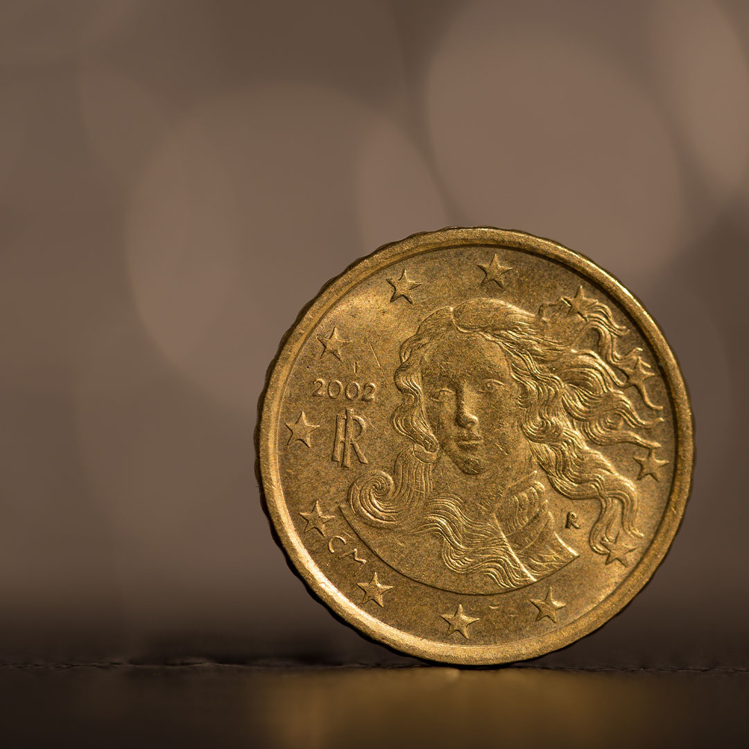 Examining rare coin with magnifying glass