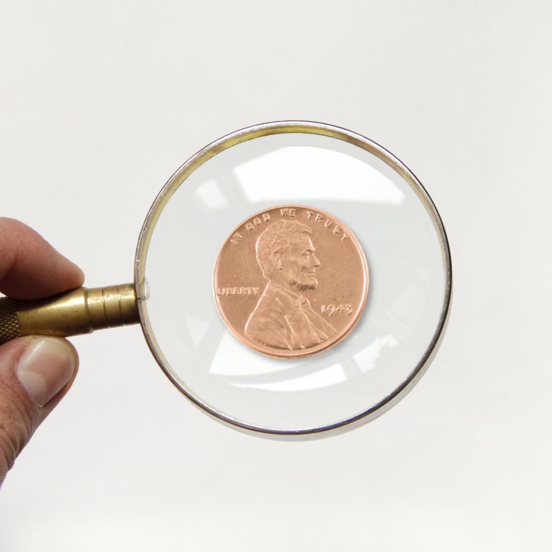 1943 penny under a magnifying glass